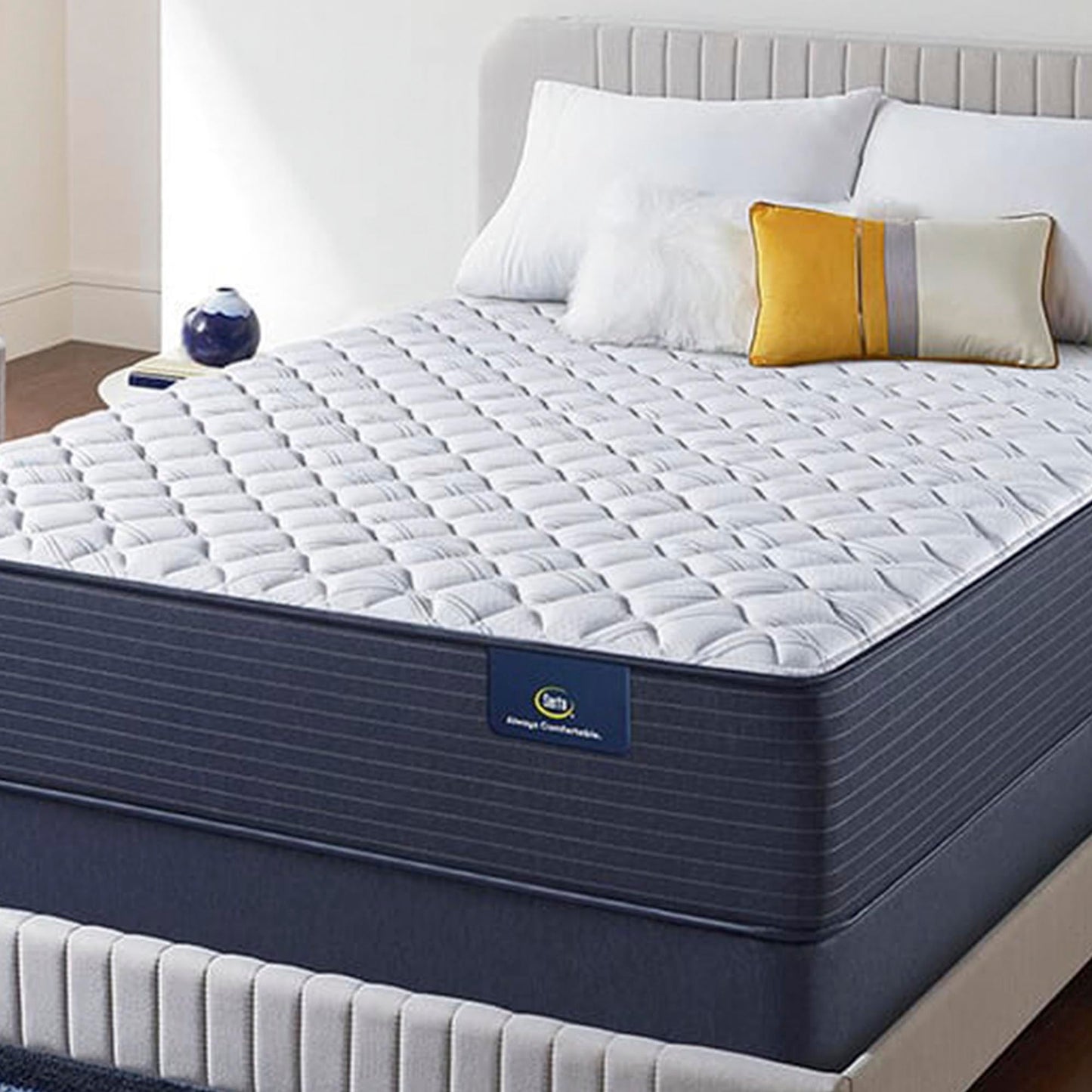 The The Serta Classic Elite Extra Firm 13" mattress in a bedroom on a beige bed