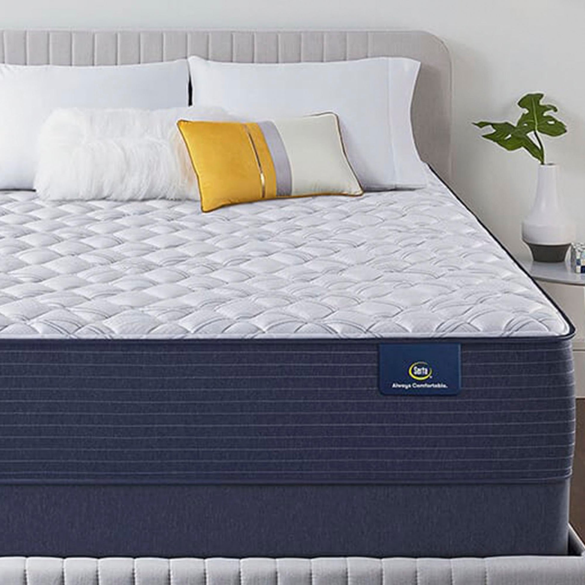 The Serta Classic Elite Extra Firm 13" mattress in a bedroom on a grey bed