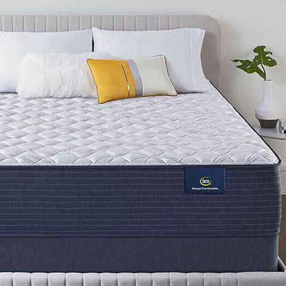 The Serta Classic Elite Extra Firm 13" mattress in a bedroom on a grey bed
