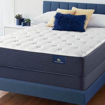 The Serta Classic Plush 11" on a blue bed in a bedroom