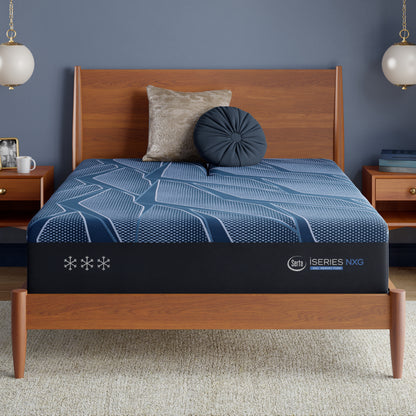 Blue Serta iSeries NXG mattress with a brand logo on a wooden bed frame in a bedroom setting.