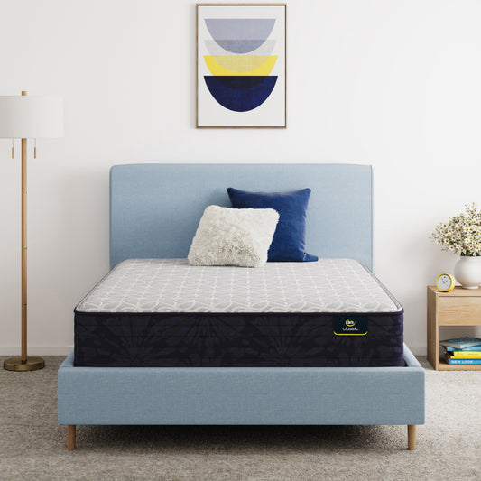 Serta Classic Clarks Hill Mattress on a bed with a blue headboard in a room setting