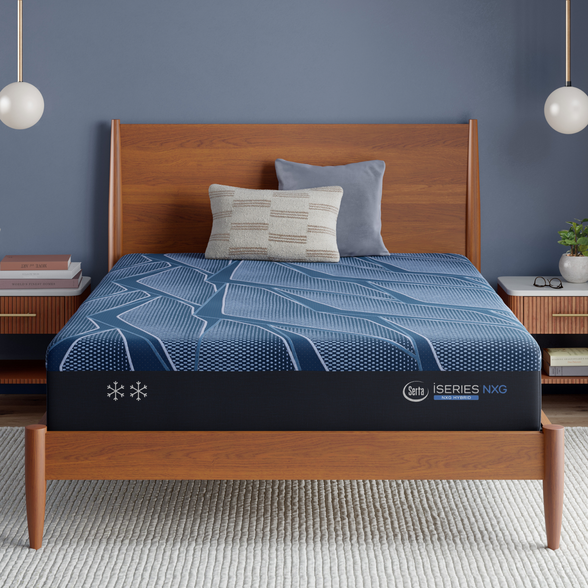 Blue Serta iSeries NXG Hybrid mattress on a wooden bed frame with pillows in a bedroom setting.