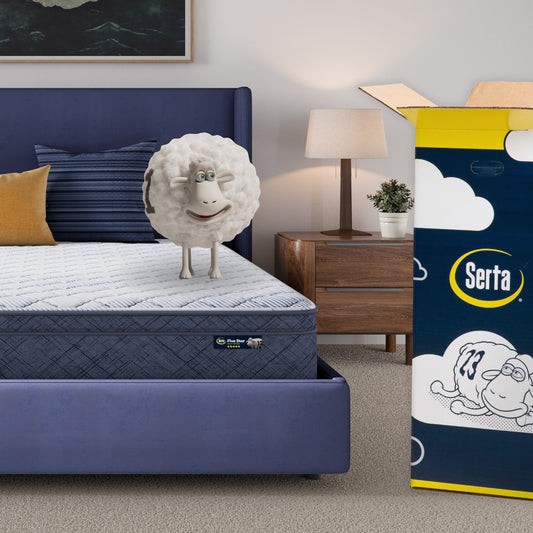 10 inch plush pillow top mattress in a blue bedframe with a Serta sheep with a number on top of it with the Serta packaging to the right of the bed
