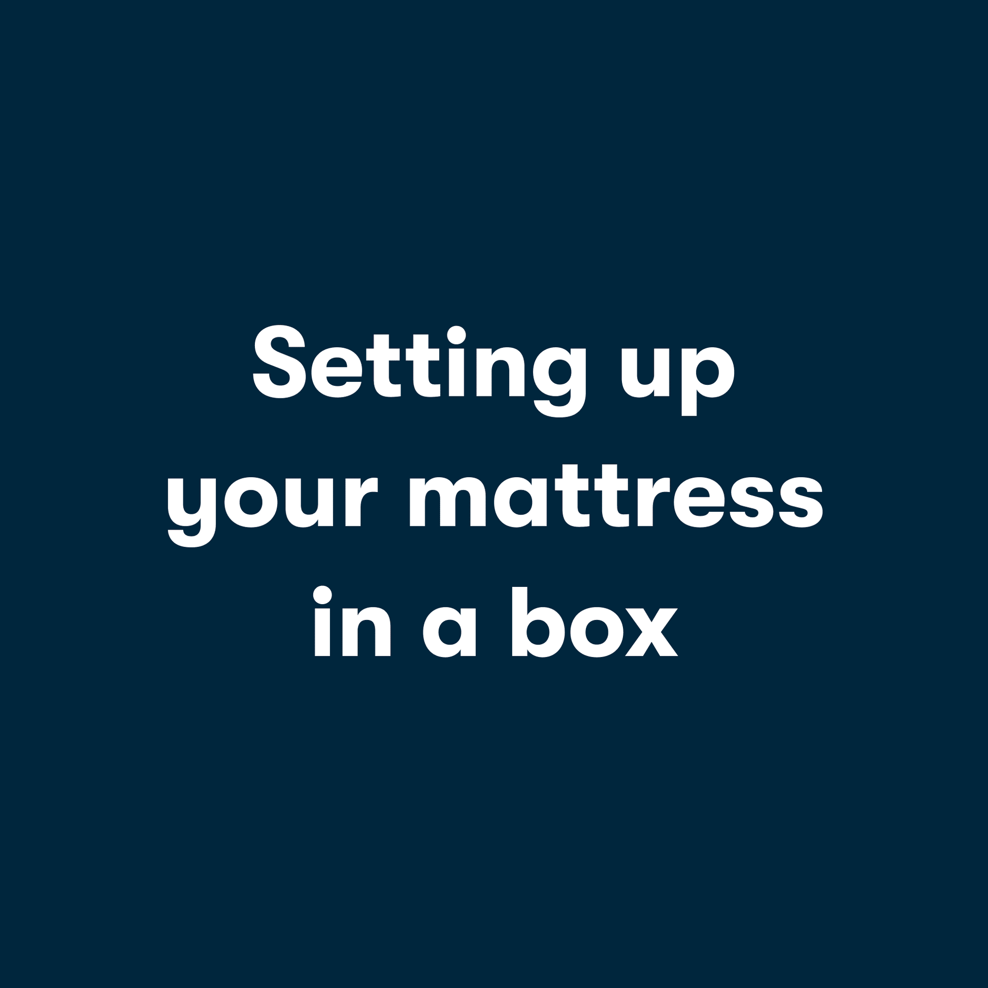 Gif video of a couple opening a mattress in a box, unrolling it and then laying on it.