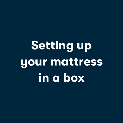 Gif video of a couple opening a mattress in a box, unrolling it and then laying on it.