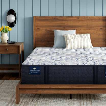 Perfect Sleeper Pro Hampton Extra Firm mattress sitting in a brown bedframe || level: Level 1 || feel: Extra Firm