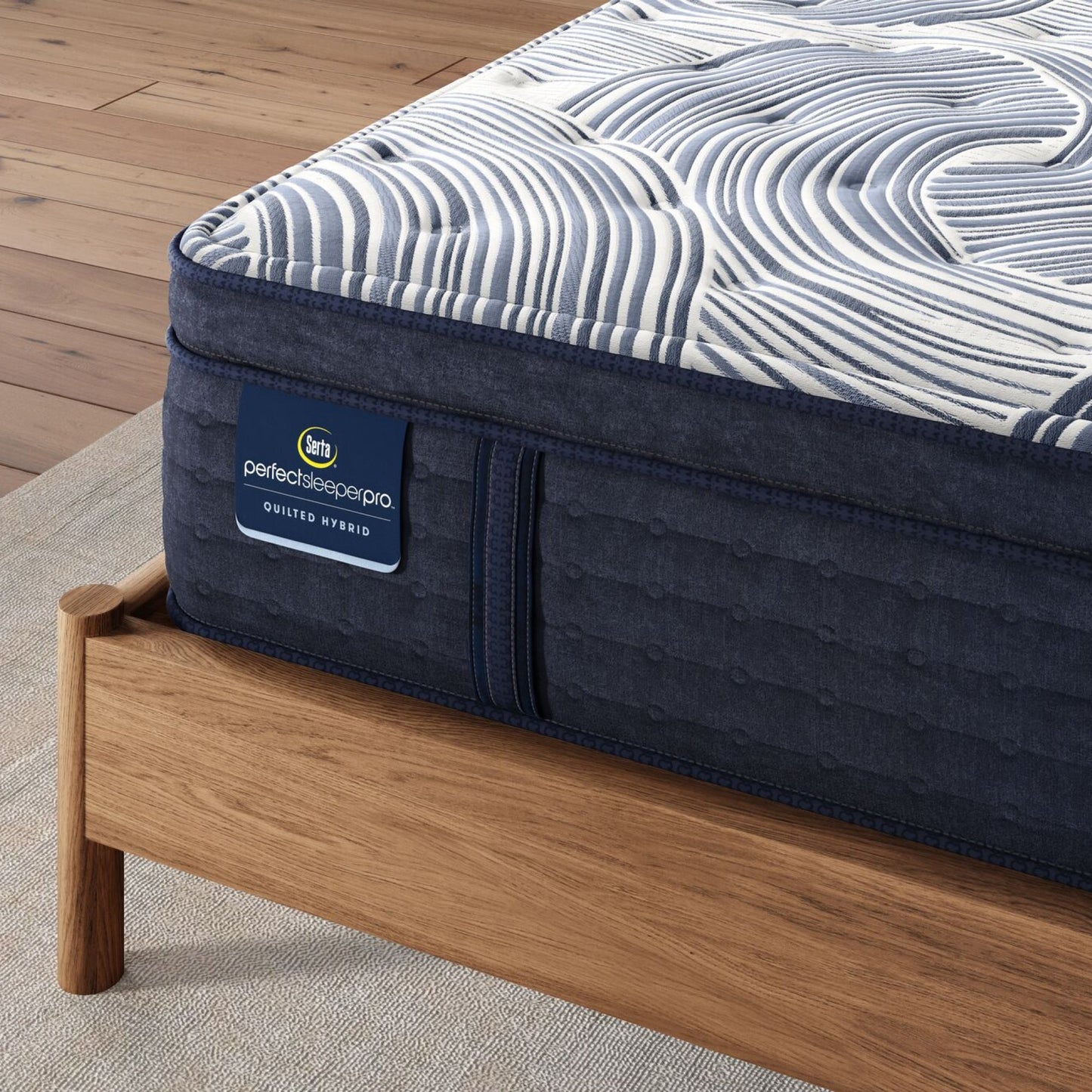 Corner of Perfect Sleeper Pro Edinburgh Plush Pillow Top mattress sitting in a brown bedframe || Level: Level 2 || Feel: Plush Pillow Top
