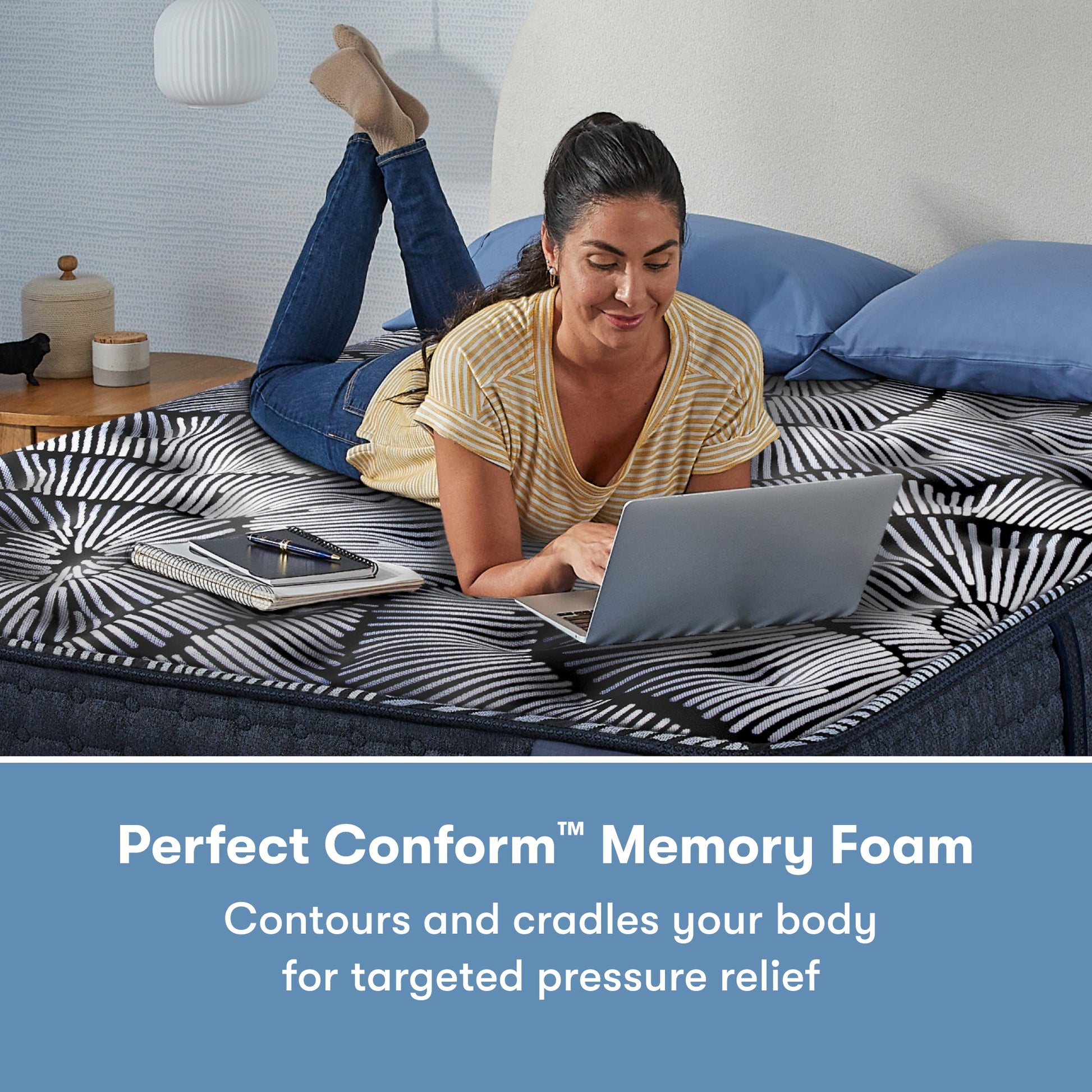 Woman laying on her stomach using her laptop on a Perfect Sleeper X Quilted Hybrid Max Plush Pillow Top Mattress || feel: Plush Pillow Top || level: Level 2