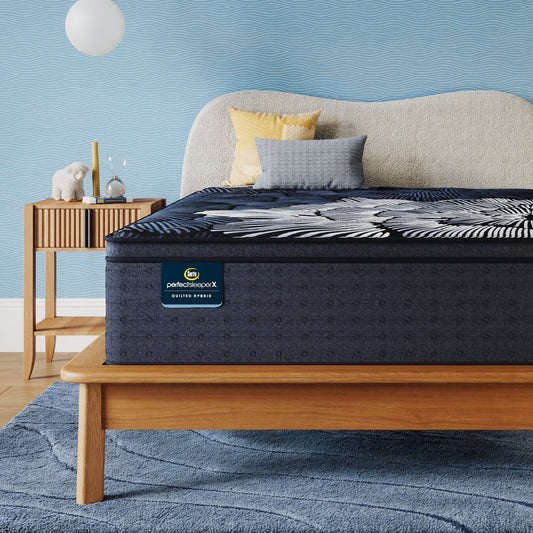 Perfect Sleeper X Quilted Hybrid Max Plush Pillow Top Mattress sitting in a brown bedframe || feel: Plush Pillow Top || level: Level 2