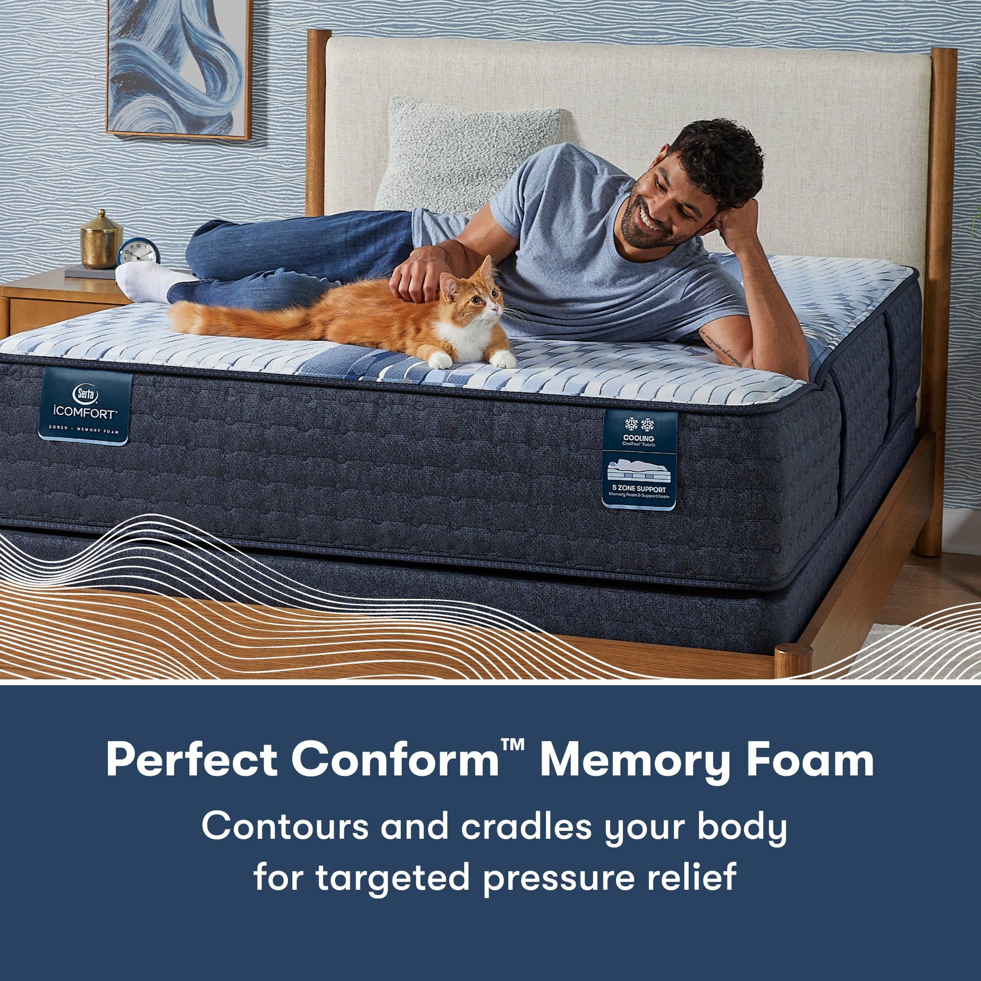 Man laying across a Serta iComfort mattress petting a cat || feel: medium || level: Standard - 13"