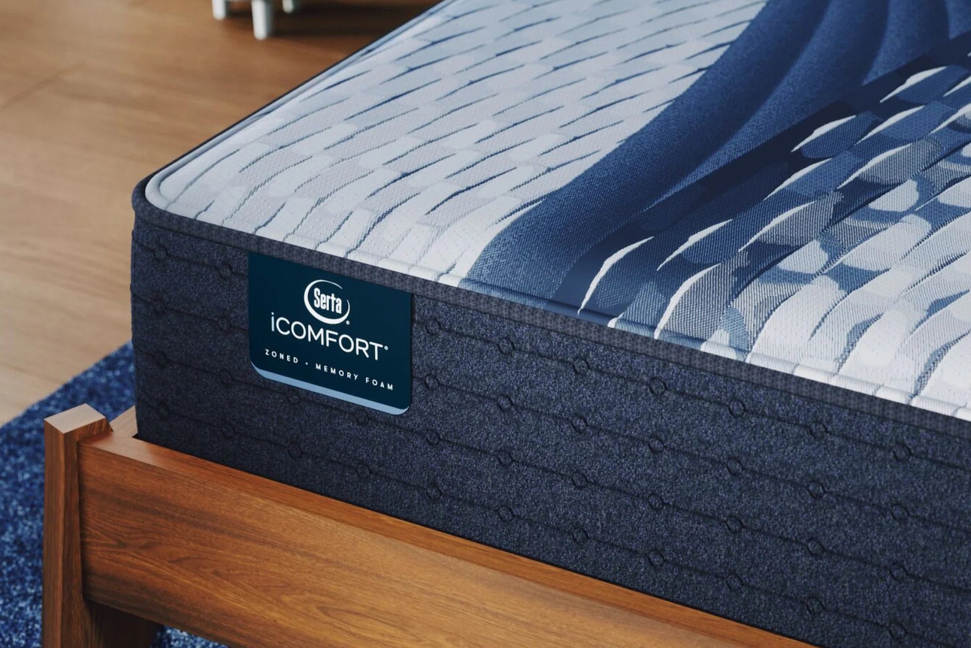 Close-up of a Serta iComfort Plush mattress, featuring 5-zone support, pressure-relieving memory foam, and cool-to-the-touch fabric.