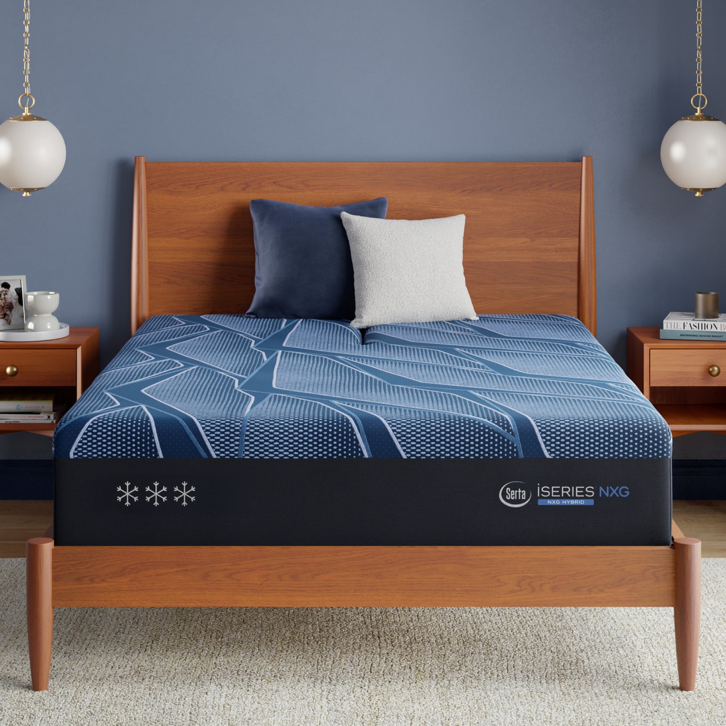 Blue Serta® iSeries® NXG™ mattress on a wooden bed frame with a dark blue wall and wooden nightstands.