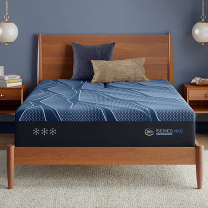 Bed frame with a blue Serta iSeries NXG mattress topper in a bedroom setting