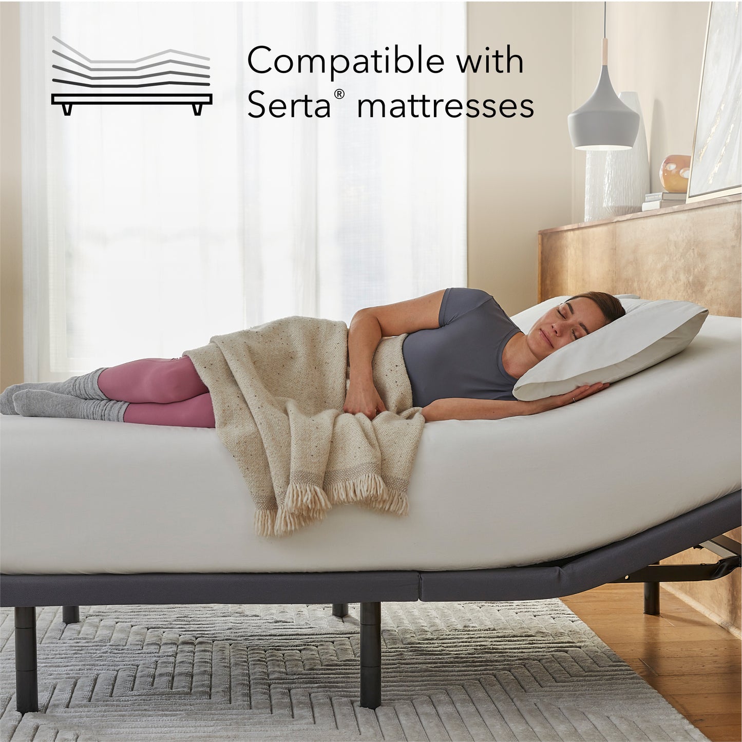 Woman laying asleep on a white mattress sitting on a Baselogic Gold Adjustable Base