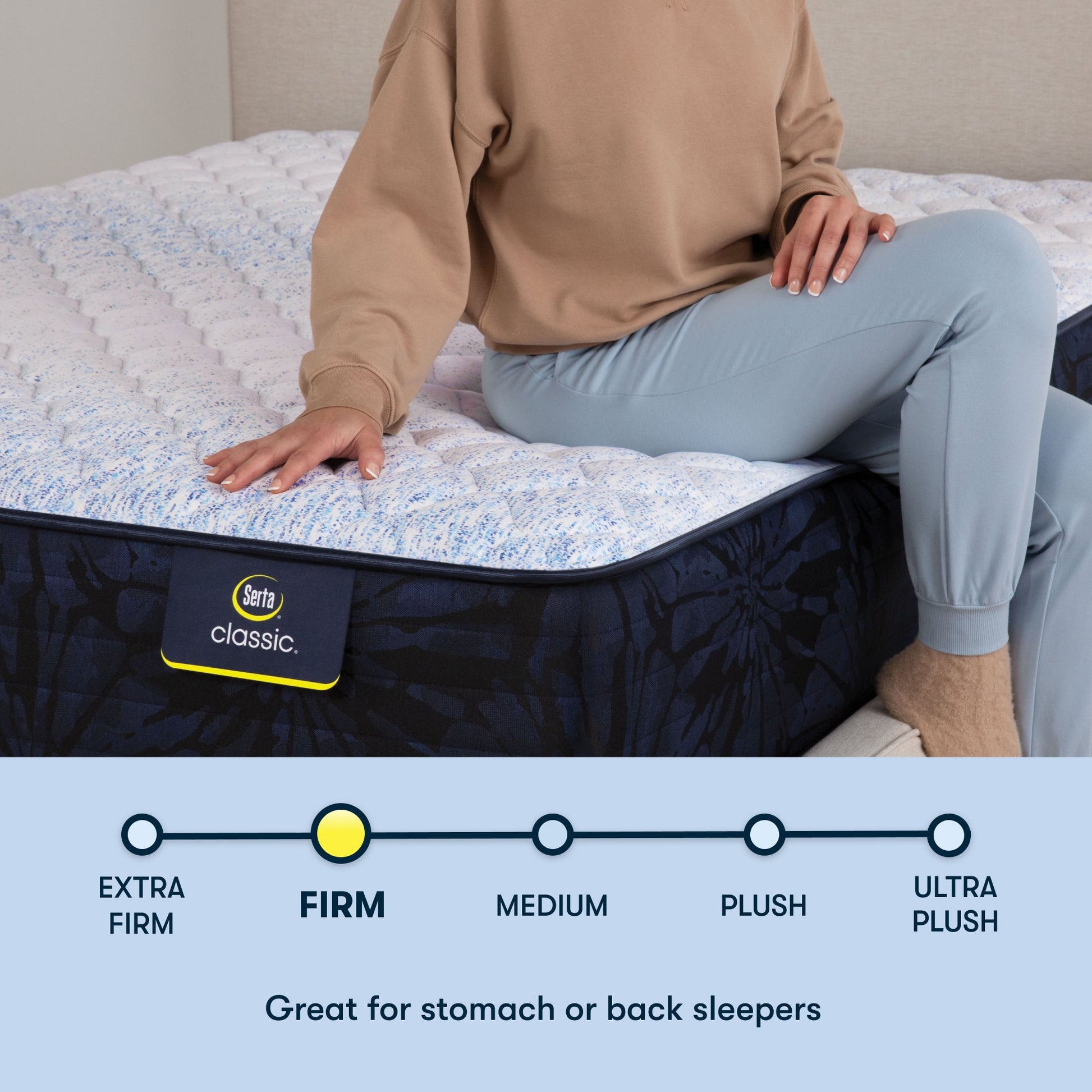 Woman sitting on a Serta classic firm mattress with her right hand placed on the mattress ||feel: firm ||level: standard